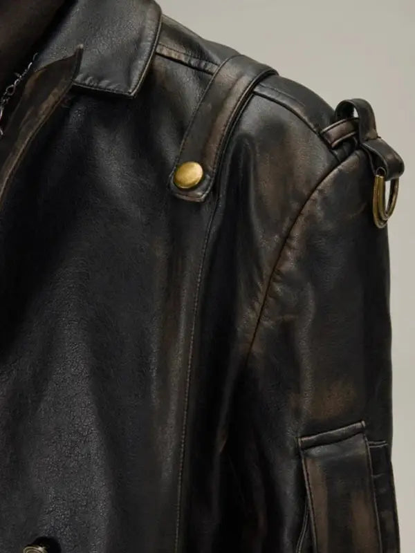 Black leather jacket with brass snap buttons and pockets.