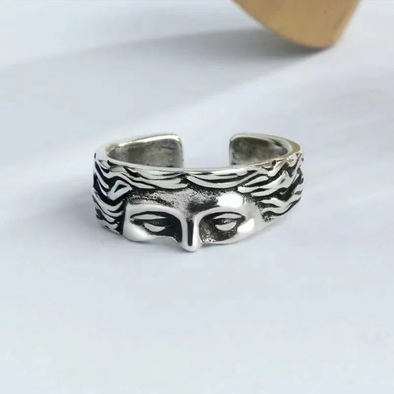 Silver masked faces ring with adjustable open-band and elegant metal finish