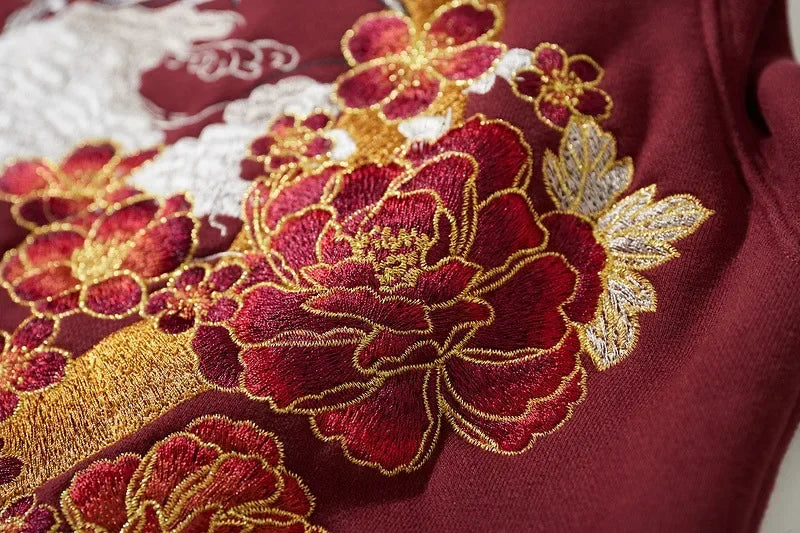 Burgundy fabric with floral embroidery on the Mythical Dragon Embroidered Hoodie