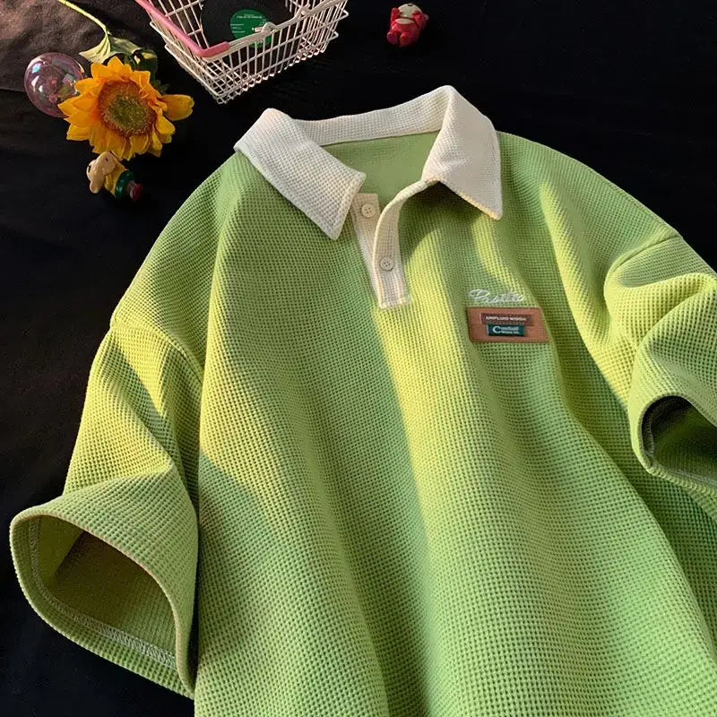 Lime green polo shirt with white collar and small brand patch.