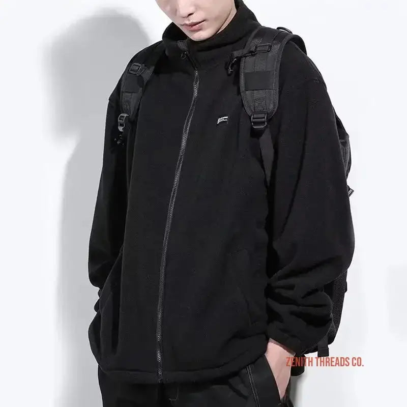 Black zip-up fleece jacket with shoulder straps.