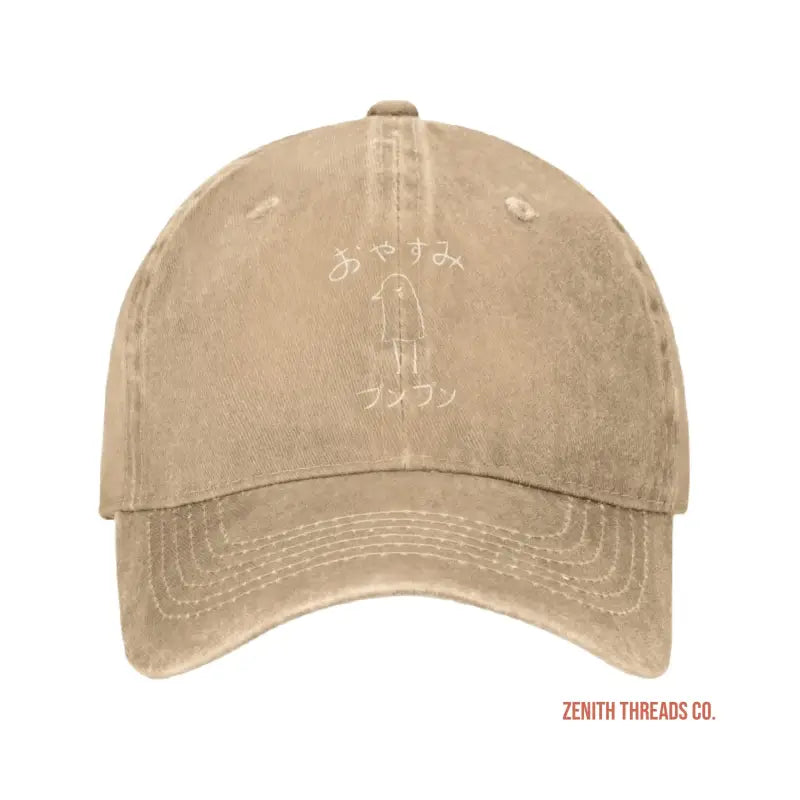 Beige baseball cap with Japanese text and a small figure design.