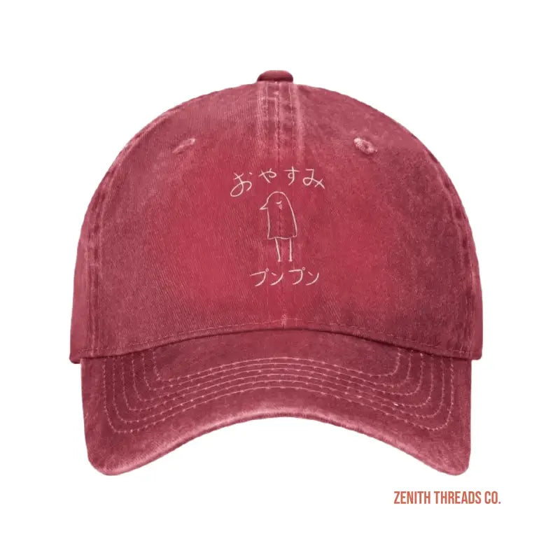 Red baseball cap with Japanese text and a simple stick figure design embroidered on the front.