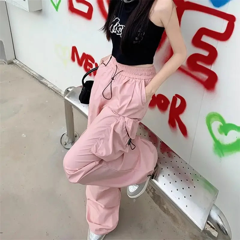 Pink cargo pants featuring durable polyester in Parachute Black Cargo Y2K streetwear style