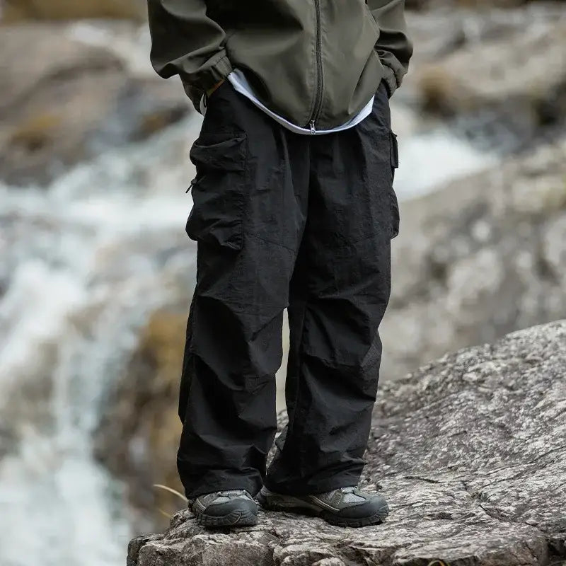 Black cargo pants with multiple pockets and a relaxed fit.