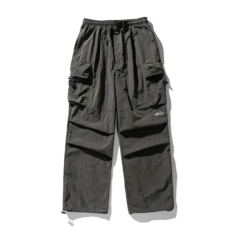 Dark gray cargo pants with multiple pockets and drawstring waist.