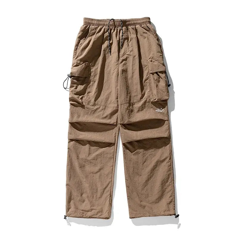 Khaki cargo pants with drawstring waist and multiple side pockets.