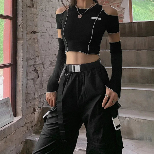 Black crop top with solderless sleeves paired with cargo pants in gothic patchwork style