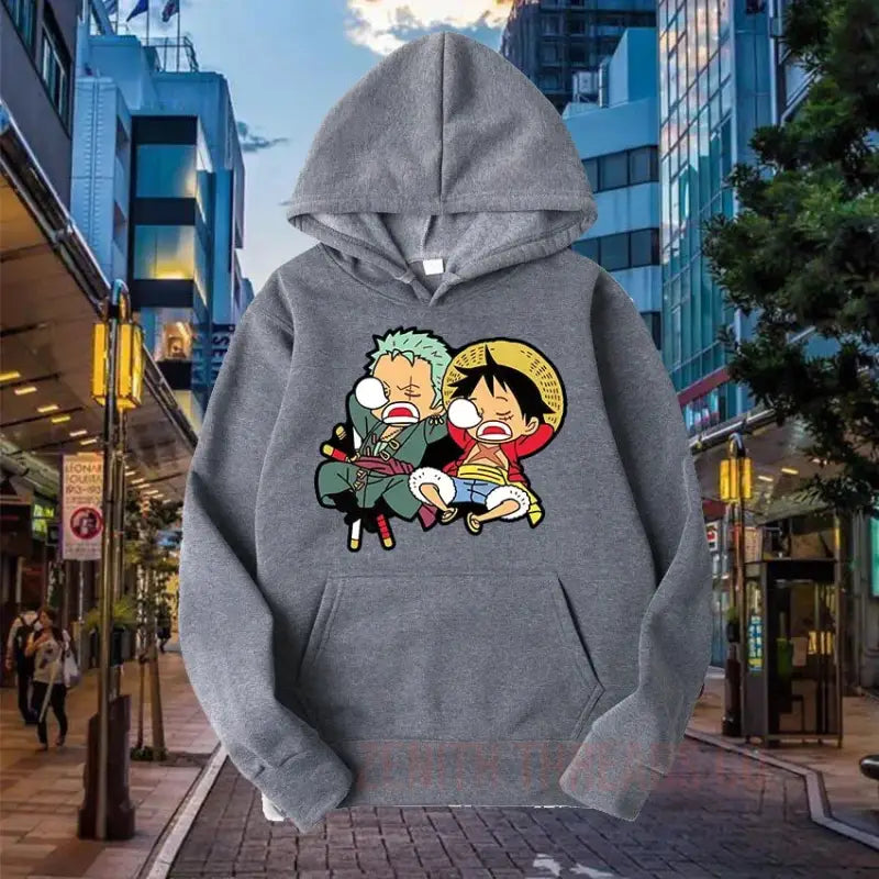 Grey hoodie featuring a cute One Piece anime design with Luffy and Zoro characters.