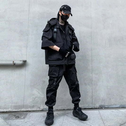 Person in black tactical clothing wearing a Shadow Weave Techwear Hooded Cargo Jacket