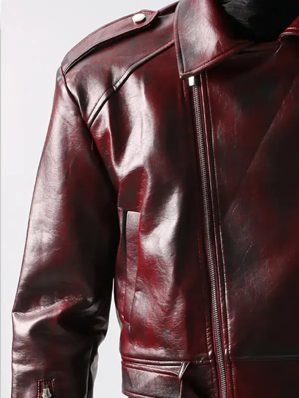 Glossy burgundy leather jacket with zipper and shoulder epaulettes.