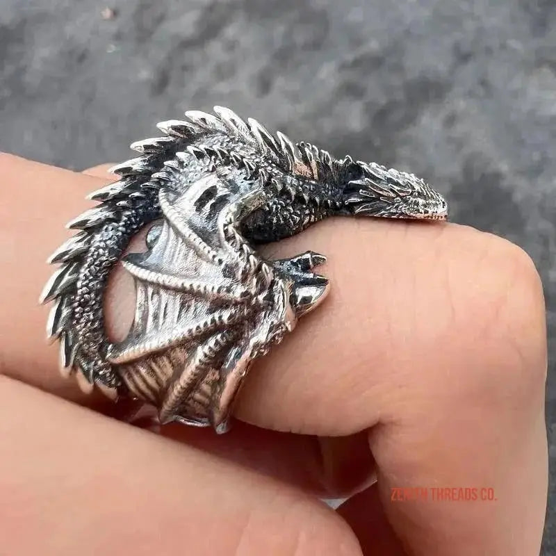 Silver dragon-shaped ring with detailed scales and wings wrapped around the finger.