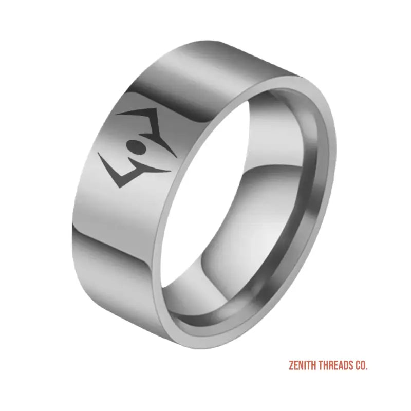 Silver metallic ring with an engraved geometric design.