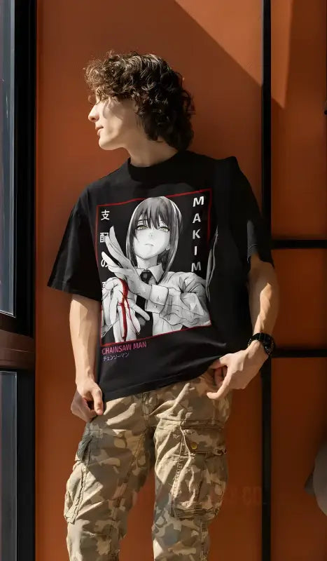 Black t-shirt featuring anime-style artwork worn with khaki cargo pants.