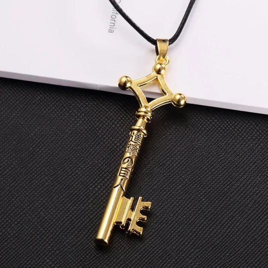 Gold key necklace in zinc alloy on a black cord, inspired by Eren’s key design