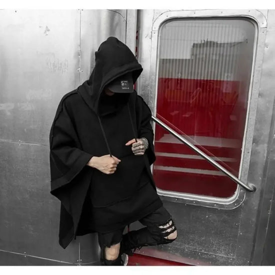 Black hooded poncho from Telisan Techwear featuring a three-dimensional pocket