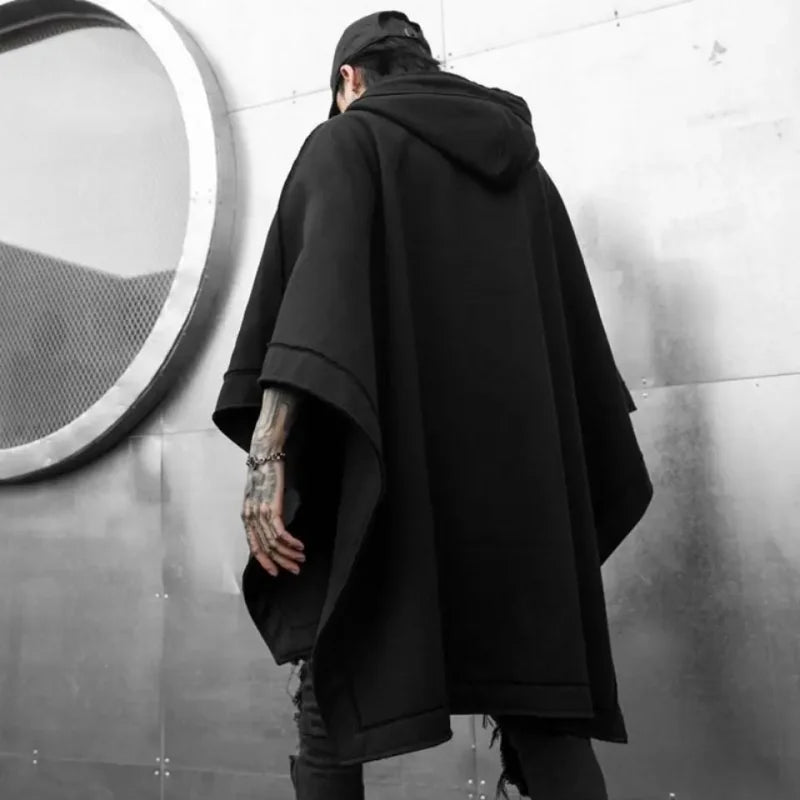 Black hooded poncho from Telisan Techwear features a three-dimensional pocket in gothic style