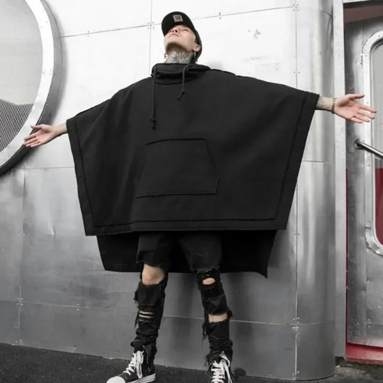 Black hooded poncho in Telisan techwear oversized baggy design with three-dimensional pocket