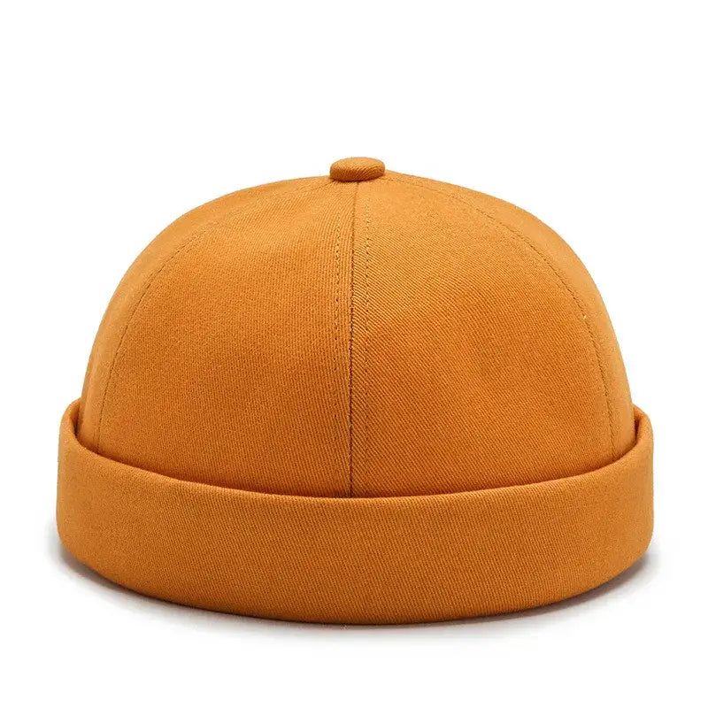 Orange cotton docker/beanie hat with a rolled brim.