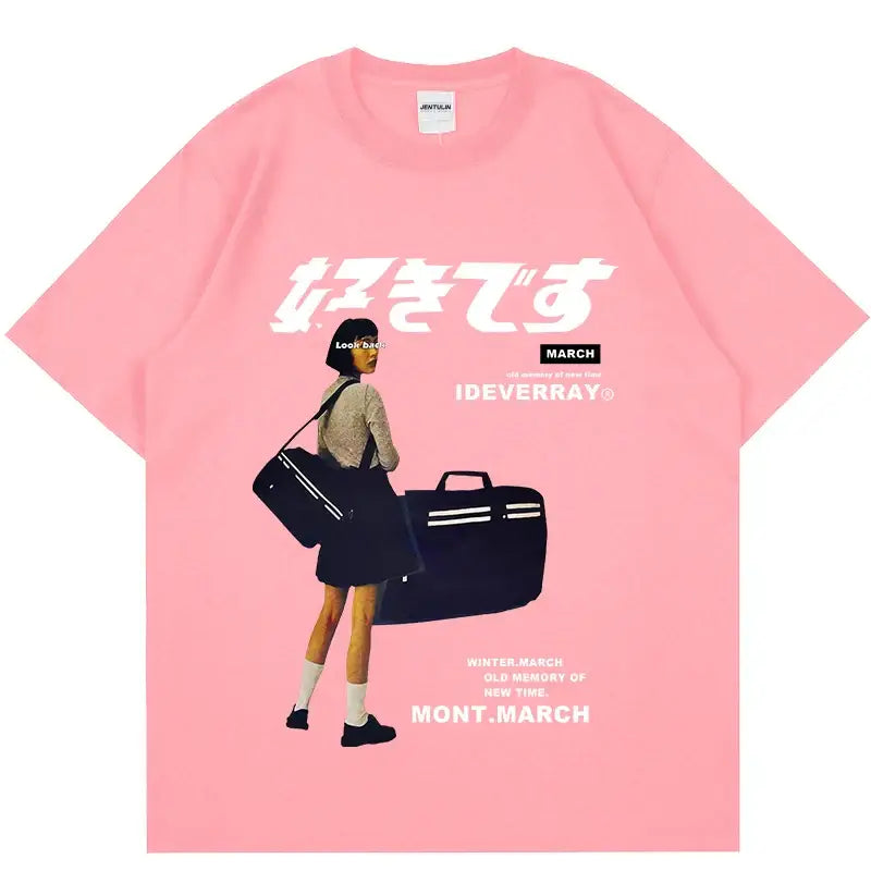 Pink t-shirt with Japanese text and an illustration of a person carrying luggage.