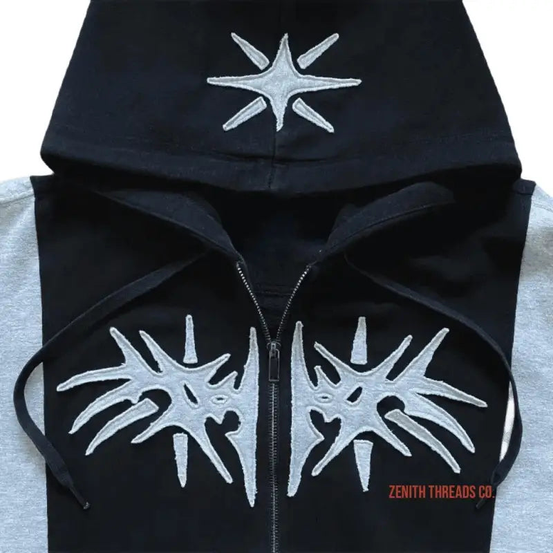 Black and grey zip-up hoodie with white spiky star designs.