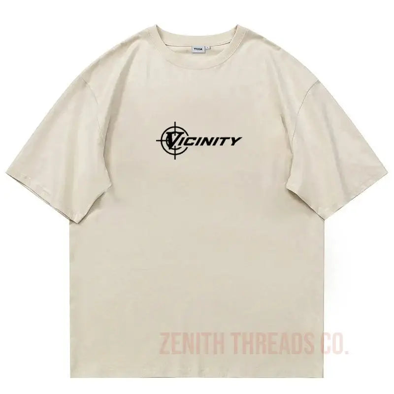 Beige t-shirt with black ’Vicinity’ logo and crosshair design.