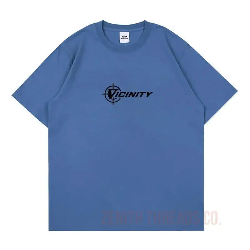 Blue t-shirt with black ’Vicinity’ logo and compass design.