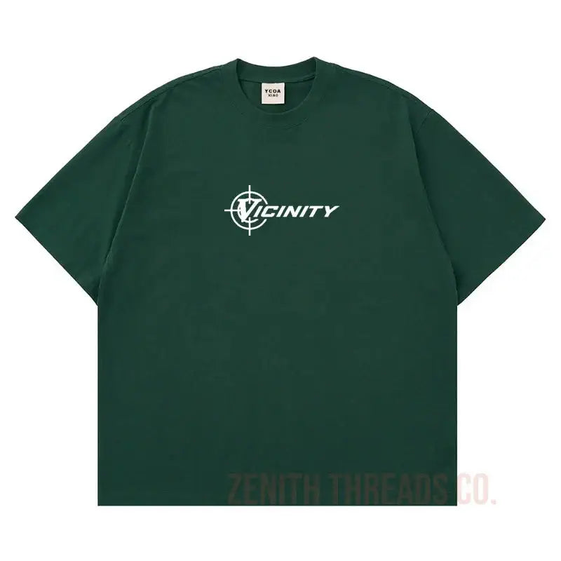 Dark green t-shirt with white ’Vicinity’ logo graphic on the front.