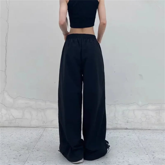 Black wide leg cargo pants with drawstring waist for a trendy Y2K fashion look