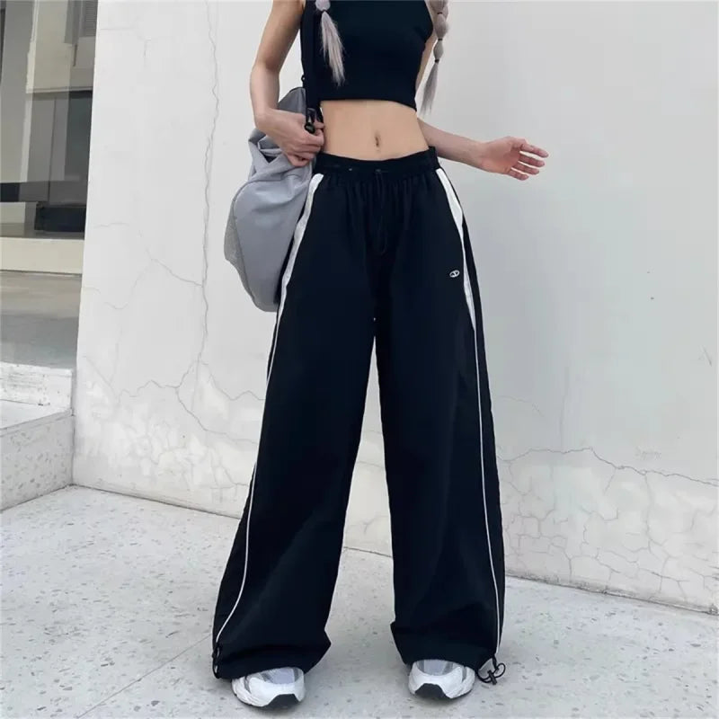 Black and white Y2K wide leg cargo pants with drawstring waist showcased on a model