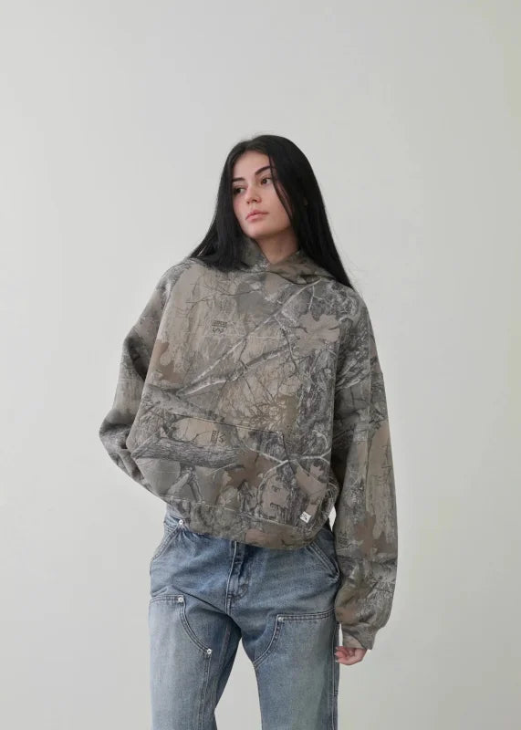 Y2K printed camouflage pattern pullover hoodie paired with blue jeans for trendy streetwear