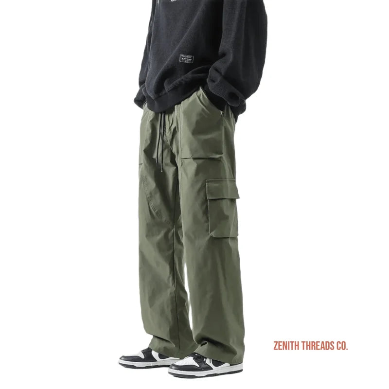 Olive green cargo pants with multiple side pockets and drawstring waist.