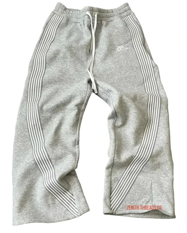 Gray Nike sweatpants with striped side panels and drawstring waist.